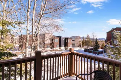 a balcony with a bench on a wooden deck at Lakepoint 807C - Frisco in Frisco
