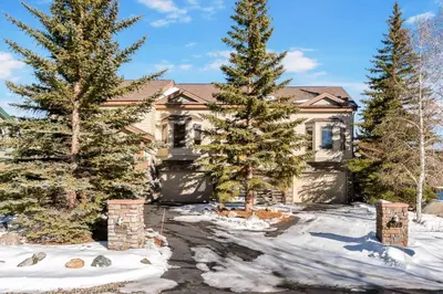 a house with two pine trees in the snow at Lakepoint 807C - Frisco in Frisco
