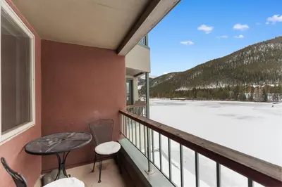 a balcony with a table and chairs and a view at Lakeshore 1535 in Keystone