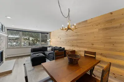 a living room with a wooden wall at Lakeshore 1535 in Keystone