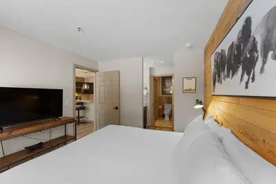 a bedroom with a large bed and a flat screen tv at Lakeshore 1535 in Keystone