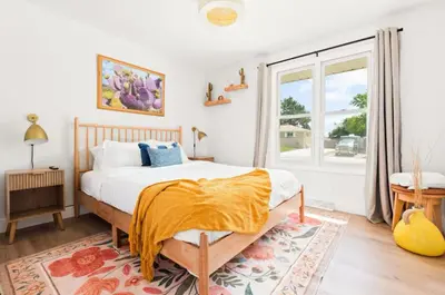 a bedroom with a bed and a large window at Fam Retreat, Hot Tub, BBQ, Ski, Game Room, Backyard in Arvada