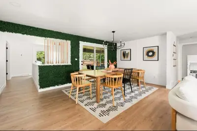 a dining room and living room with a table and chairs at Fam Retreat, Hot Tub, BBQ, Ski, Game Room, Backyard in Arvada