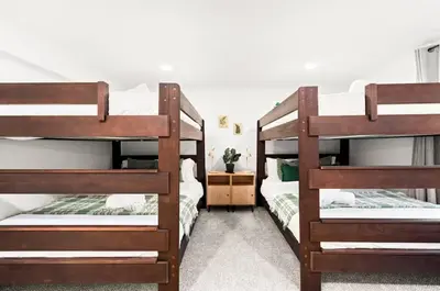 a bedroom with three bunk beds in a room at Fam Retreat, Hot Tub, BBQ, Ski, Game Room, Backyard in Arvada