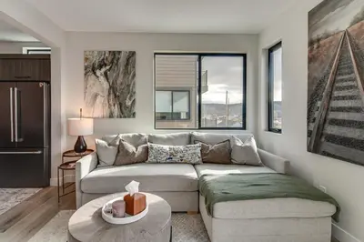 a living room with a couch and a table at 4 Mi to Granby Ranch Gem with Balcony and Mtn Views! in Granby