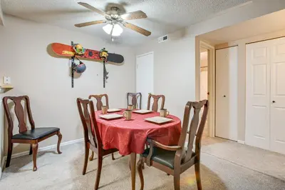 a dining room with a table with a snowboard on the wall at 3 Mi to Buckley Convenient Condo in Aurora in Aurora