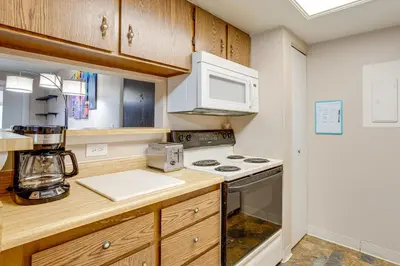 a kitchen with a stove and a microwave at 3 Mi to Buckley Convenient Condo in Aurora in Aurora