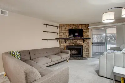 a living room with a couch and a fireplace at 3 Mi to Buckley Convenient Condo in Aurora in Aurora