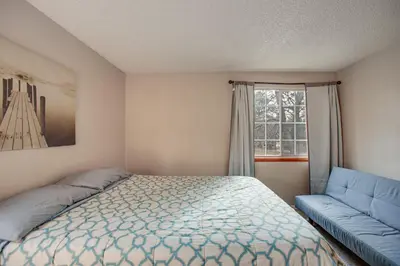 a bedroom with a bed and a couch and a window at 3 Mi to Buckley Convenient Condo in Aurora in Aurora