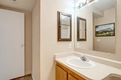 a bathroom with a sink and a mirror at 3 Mi to Buckley Convenient Condo in Aurora in Aurora