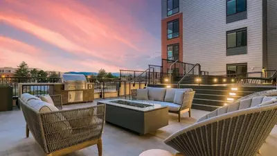 a patio with chairs and a grill on a building at Landing Chic Studio in Fort Collins in Fort Collins