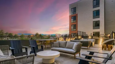 a patio with chairs and tables on a building at Landing Chic Studio in Fort Collins in Fort Collins