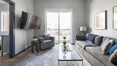 a living room with a couch and a tv at Landing Chic Studio in Fort Collins in Fort Collins