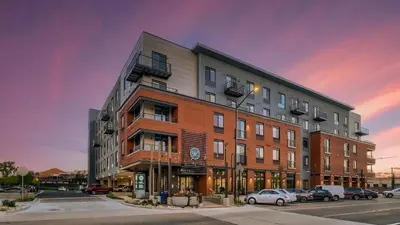 a large building with cars parked in a parking lot at Landing Chic Studio in Fort Collins in Fort Collins
