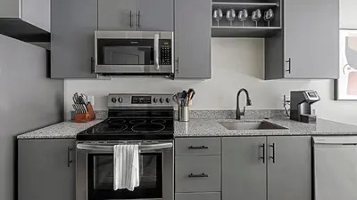 a kitchen with a stove and a microwave at Landing Chic Studio in Fort Collins in Fort Collins