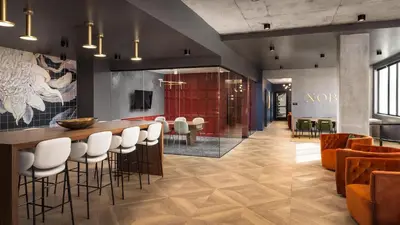 a lobby with a bar with white stools at Landing Stunning Studio Rooftop Lounge Gym in Englewood