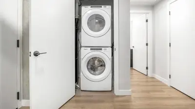 a washer and dryer in a room with a hallway at Landing Stunning Studio Rooftop Lounge Gym in Englewood