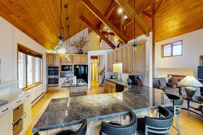 a kitchen and living room with a large island at Tenmile Vista Retreat in Silverthorne