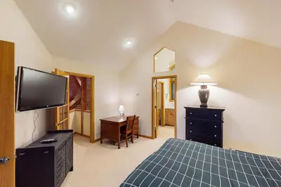 a bedroom with a bed and a flat screen tv at Tenmile Vista Retreat in Silverthorne