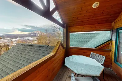 a room with a balcony with a bench and a window at Tenmile Vista Retreat in Silverthorne