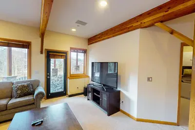a living room with a couch and a flat screen tv at Tenmile Vista Retreat in Silverthorne