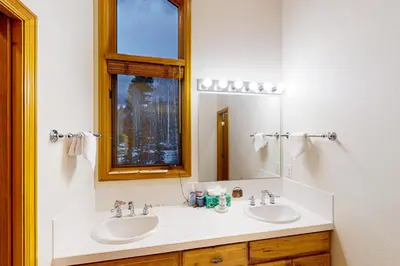 a bathroom with two sinks and a mirror at Tenmile Vista Retreat in Silverthorne