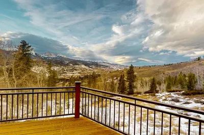 a wooden deck with a view of a snowy mountain at Tenmile Vista Retreat in Silverthorne