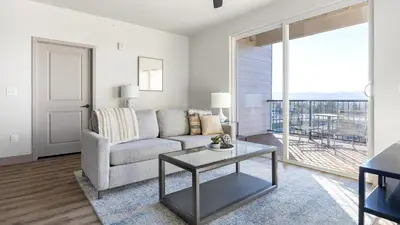 a living room with a couch and a table at Landing Incredible 1BD Gym Clubhouse in Littleton