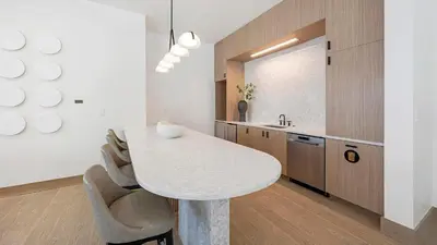a kitchen with a table and chairs and a sink at Landing Beautiful 1BD Gym Rooftop Lounge in Denver