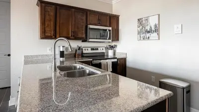 a kitchen with a sink and a microwave at Landing Amazing 2BD Pool Clubhouse in Loveland