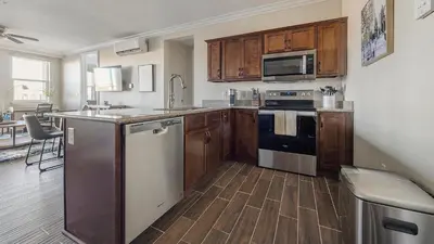a kitchen with wooden cabinets and stainless steel appliances at Landing Amazing 2BD Pool Clubhouse in Loveland