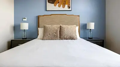 a bedroom with a large white bed with two lamps at Landing Amazing 2BD Pool Clubhouse in Loveland
