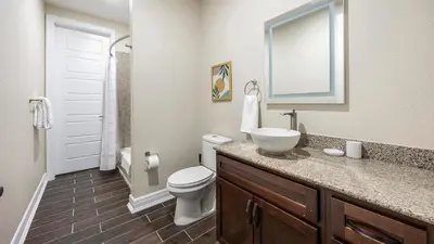 a bathroom with a sink and a toilet and a mirror at Landing Amazing 2BD Pool Clubhouse in Loveland