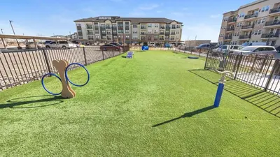 a batting cage with two tennis rackets on the grass at Landing Amazing 2BD Pool Clubhouse in Loveland