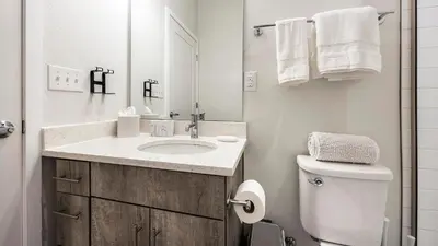 a white bathroom with a sink and a toilet at Landing Modern Studio Rooftop Lounge in Denver