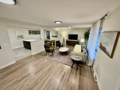 a living room with a couch and a table at Family Fun Hub - Games, Hot Tub, Putting Greens in Centennial