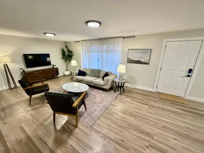 a living room with a couch and a television at Family Fun Hub - Games, Hot Tub, Putting Greens in Centennial