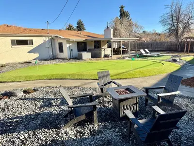 a group of chairs and a table in front of a house at Family Fun Hub - Games, Hot Tub, Putting Greens in Centennial