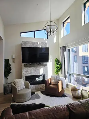 a living room with a couch and a fireplace at 4th Street Alpine Loft - New - Central Ski Hub - King Bed, Garage Parking, Hot Tub, Great Location in Silverthorne