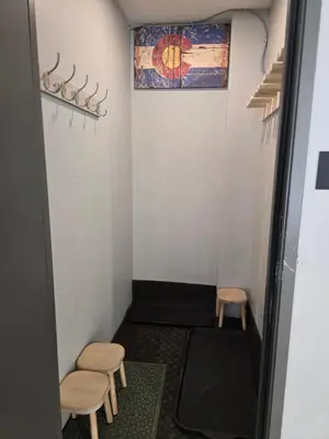 a small room with two stools and a rug at 4th Street Alpine Loft - New - Central Ski Hub - King Bed, Garage Parking, Hot Tub, Great Location in Silverthorne