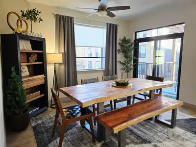 a dining room with a wooden table and chairs at 4th Street Alpine Loft - New - Central Ski Hub - King Bed, Garage Parking, Hot Tub, Great Location in Silverthorne