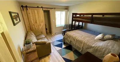 a bedroom with a bunk bed and a couch at Summit Mountain Escape in Silverthorne