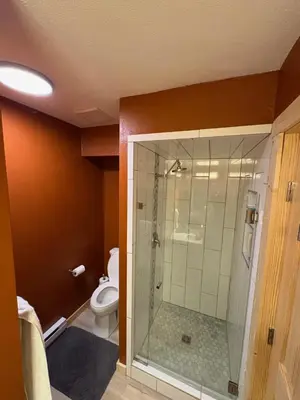 a bathroom with a toilet and a glass shower at Summit Mountain Escape in Silverthorne
