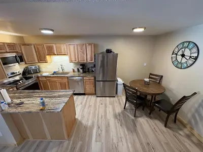 a kitchen with a table and a refrigerator at Summit Mountain Escape in Silverthorne