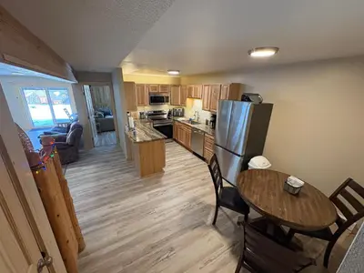 a kitchen and living room with a table and a refrigerator at Summit Mountain Escape in Silverthorne