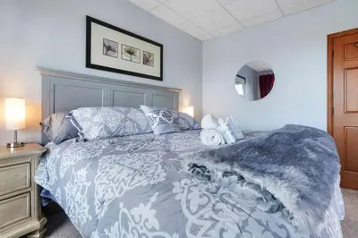 a bedroom with a bed with a blue and white comforter at Scenic Colorado Stay Near Casinos & Hot Springs in Black Hawk