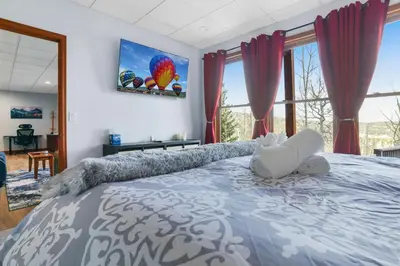 a bedroom with a large bed with a blue and white bedspread at Scenic Colorado Stay Near Casinos & Hot Springs in Black Hawk