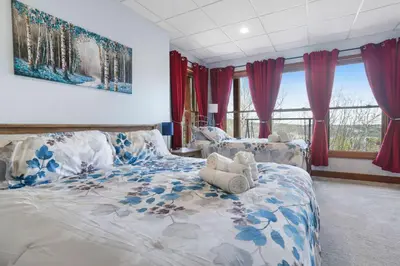 a large bedroom with a large bed with blue flowers at Scenic Colorado Stay Near Casinos & Hot Springs in Black Hawk