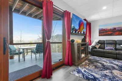 a living room with a couch and a large window at Scenic Colorado Stay Near Casinos & Hot Springs in Black Hawk