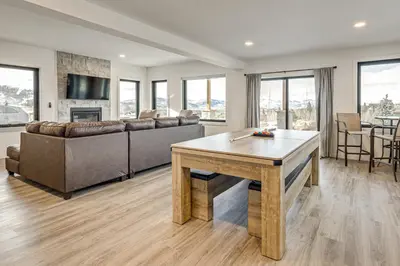 a living room with a couch and a table at 1 Mi to Granby Ranch Luxe Home with Mtn Views! in Granby